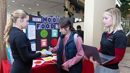 Undergraduate researchers at a 'Mood Food' display.